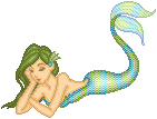 Mermaid doll laying down, arms crossed, her tail up. She has green hair and her tail is blue and green.